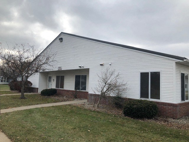 a white building with a tree in front of it