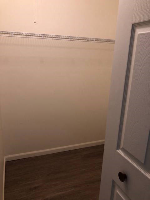 a white room with a door and a wood floor