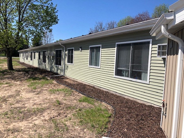 a yellow house with a yard in front of it