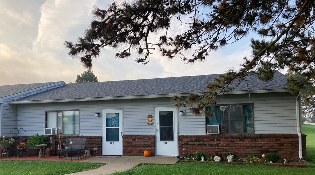 a house with a white door and a red brick wall