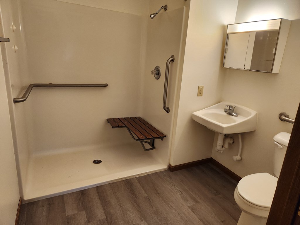 a small bathroom with a sink toilet and shower