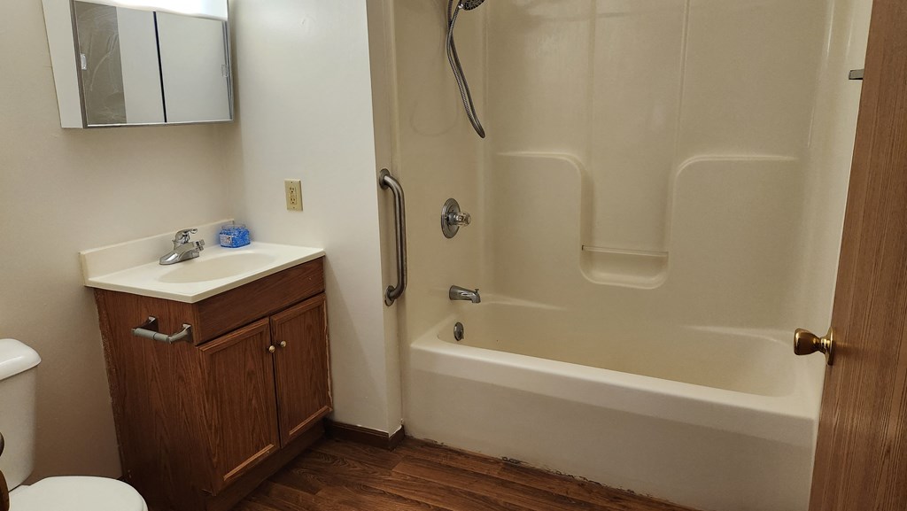a bathroom with a sink toilet and shower
