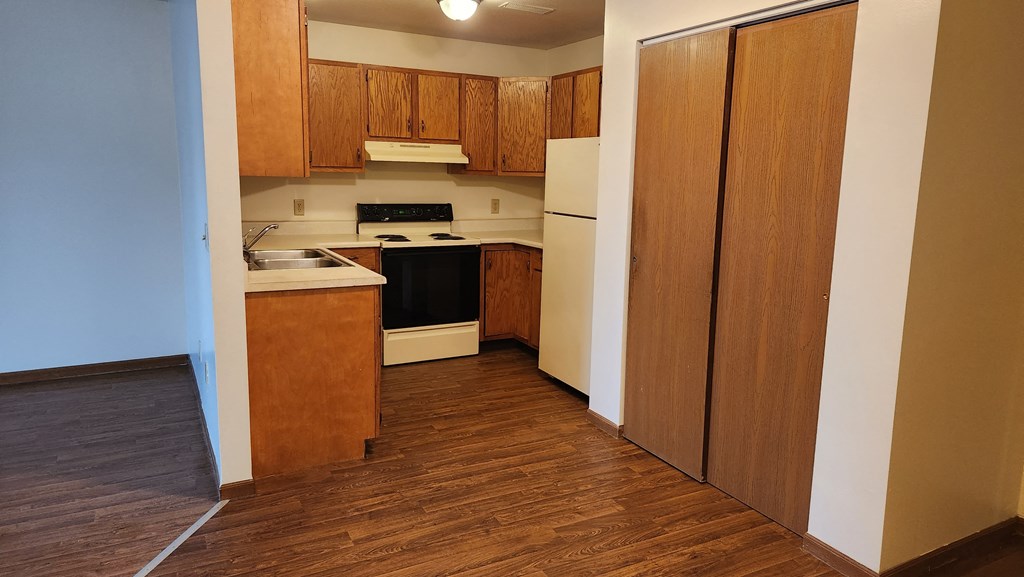 a view of the kitchen in a bedroom plus den unit at the acadia park apartments in