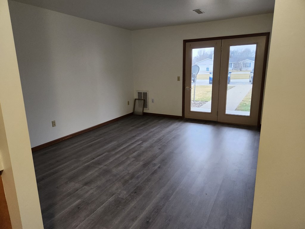 an empty room with a door and a window