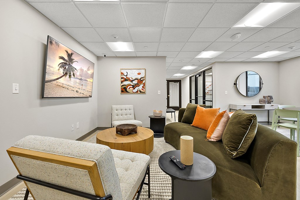 a living room with a couch and chairs and a table