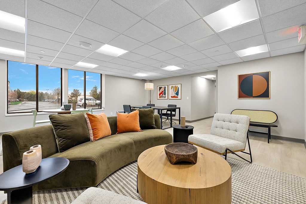 a living room with a couch and chairs and a table