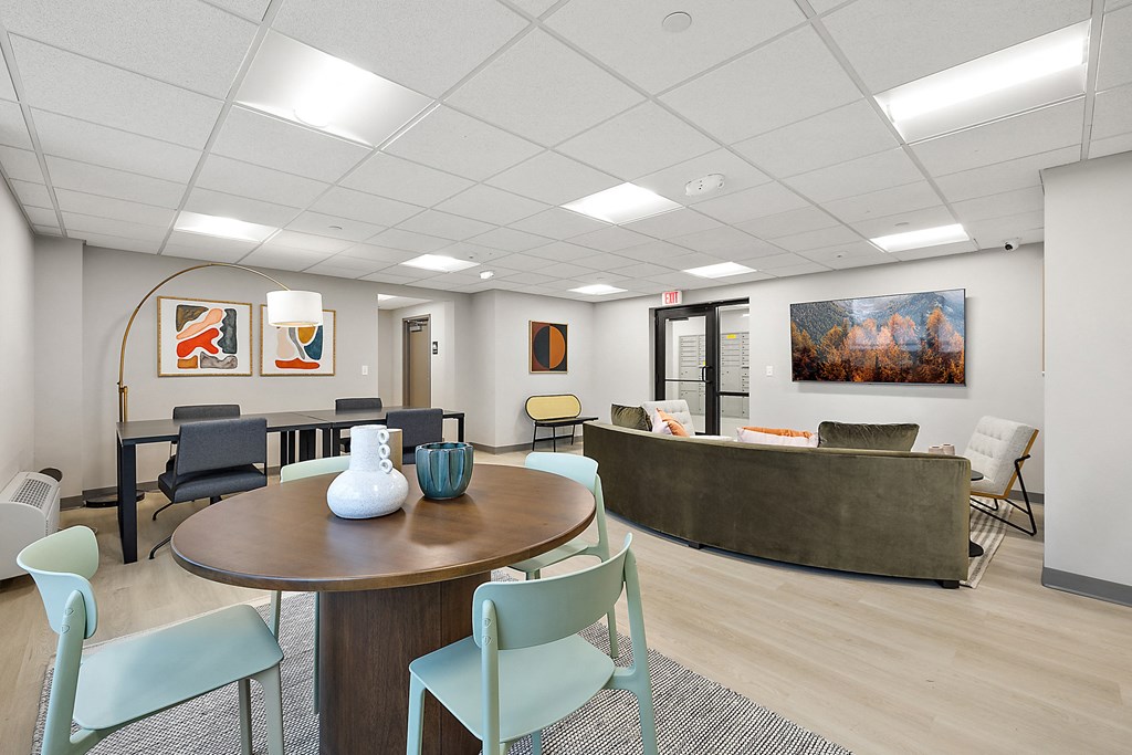 a conference room with a table and chairs and a couch