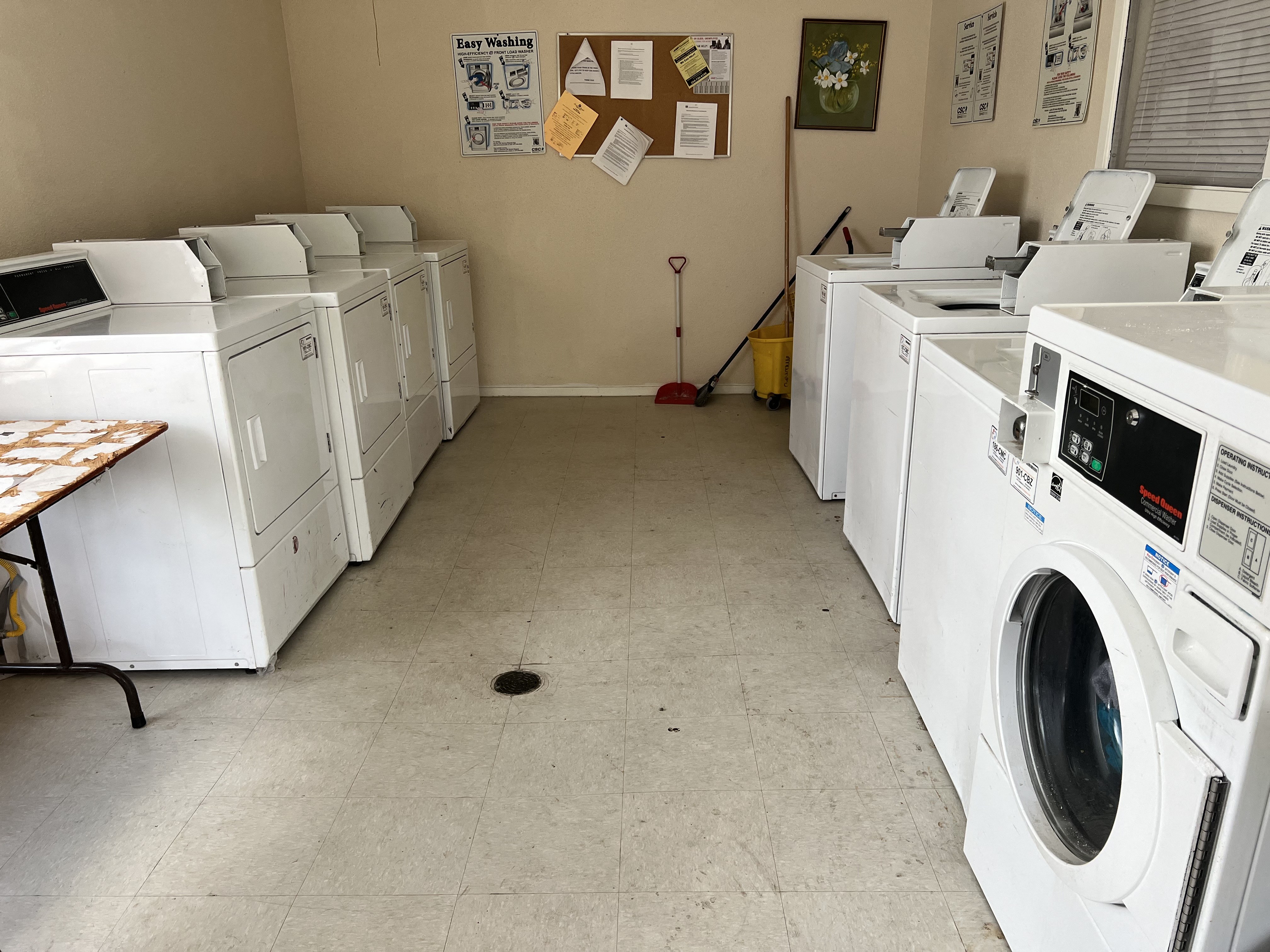 a row of washing machines in a laundromat