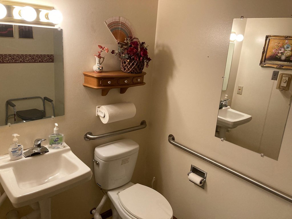 a small bathroom with a toilet sink and mirror