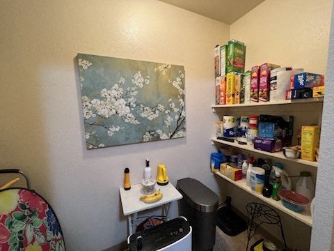 a room with a table and a painting on the wall