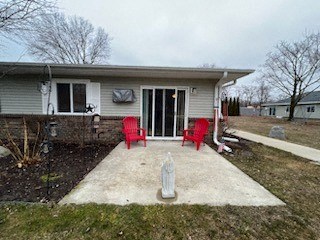 a house with a patio and two red chairs