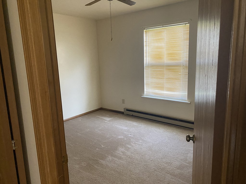 an empty room with a window and a door