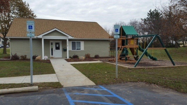 a house with a swing set in front of it