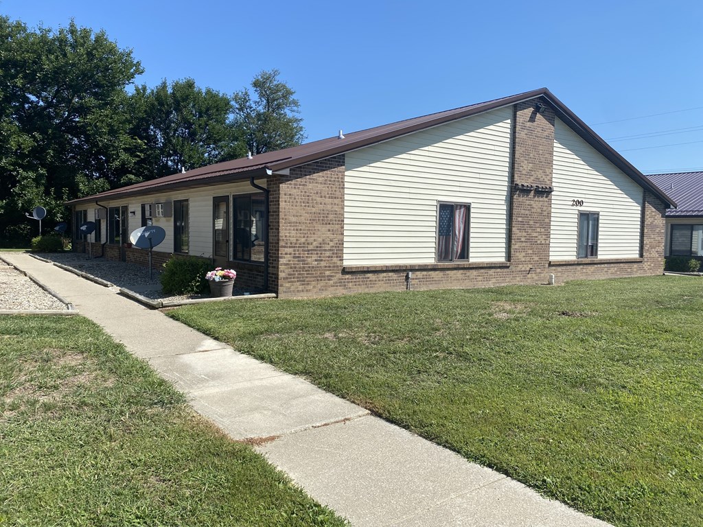 a brick and with a sidewalk and grass