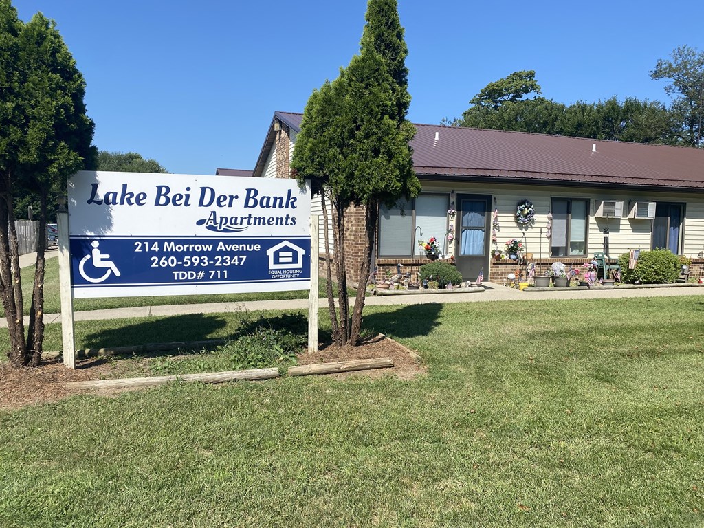 a sign in front of a building with the lake bed den bank apartments