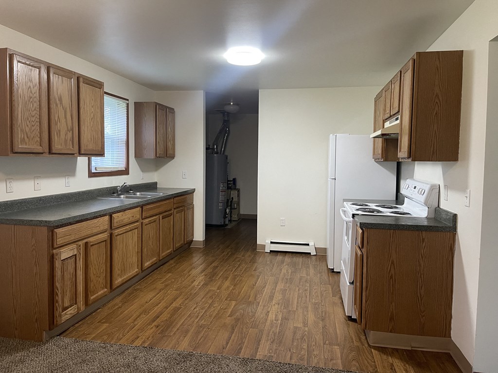 a kitchen with wooden cabinets and a white refrigerator