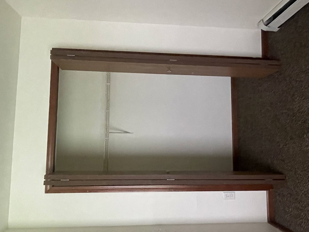 an empty medicine cabinet with a glass door