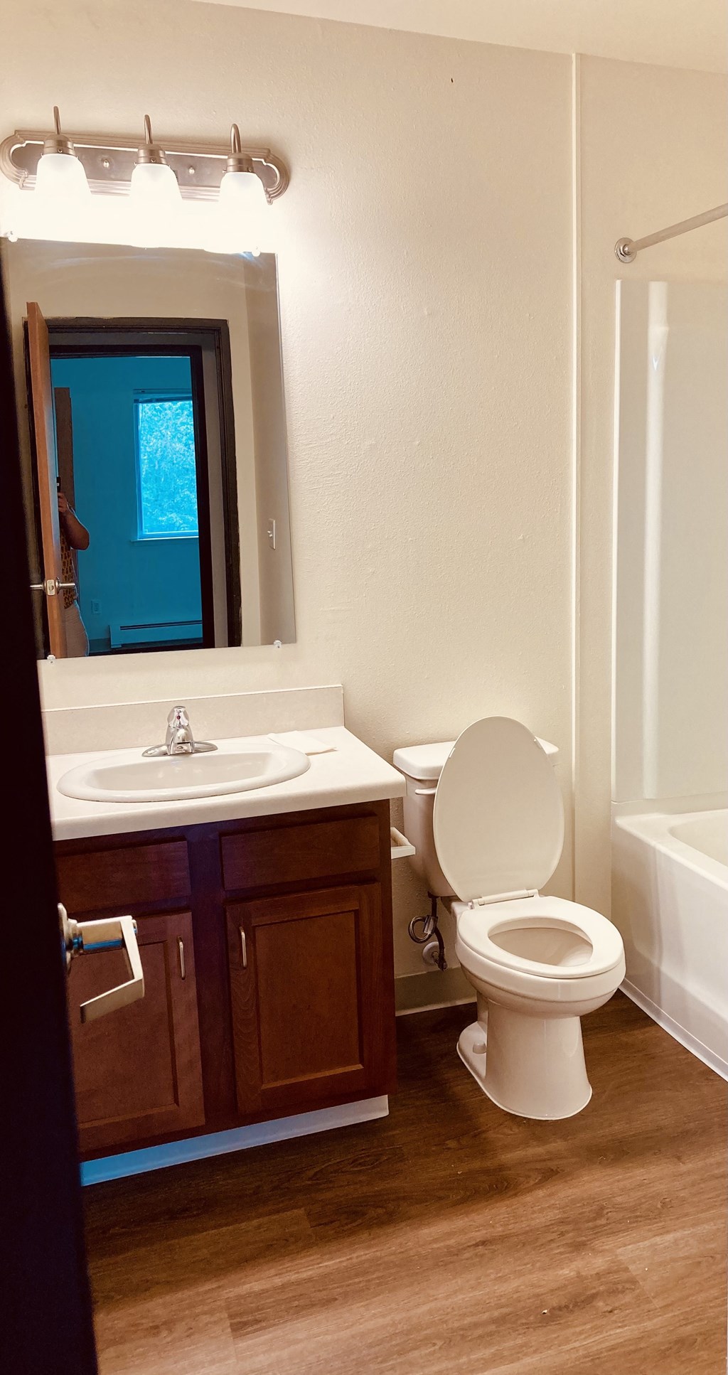 a bathroom with a toilet and a sink and a mirror