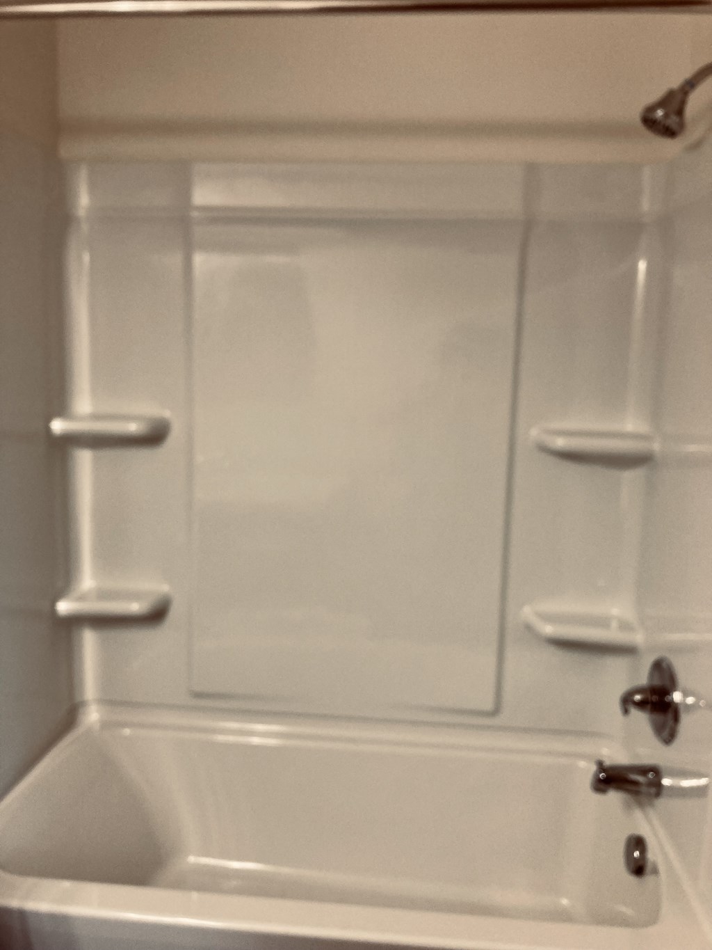 a white bathroom with a shower and a sink