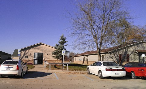 a parking lot with cars in front of a house