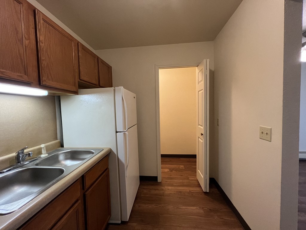 a kitchen with a white refrigerator freezer next to a sink