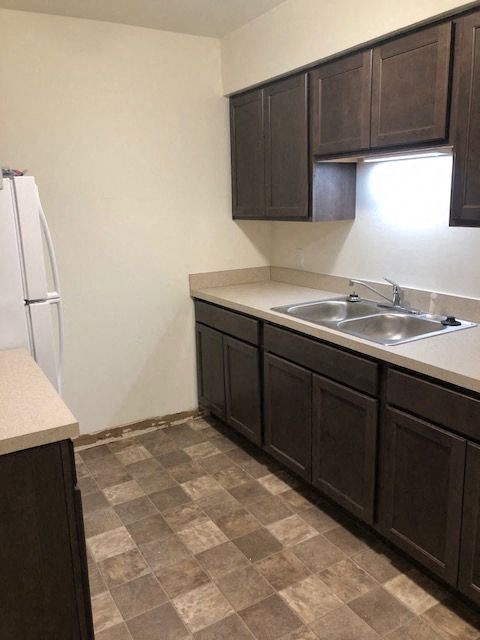 a kitchen with a sink and a refrigerator