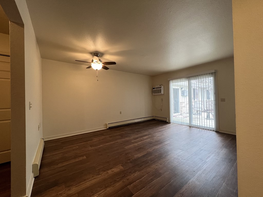 a bedroom with hardwood floors and a ceiling fan
