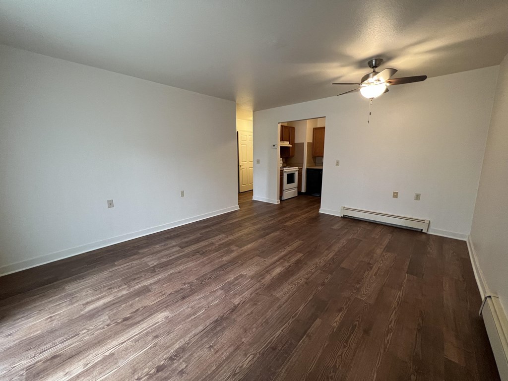 a bedroom with hardwood floors and a ceiling fan