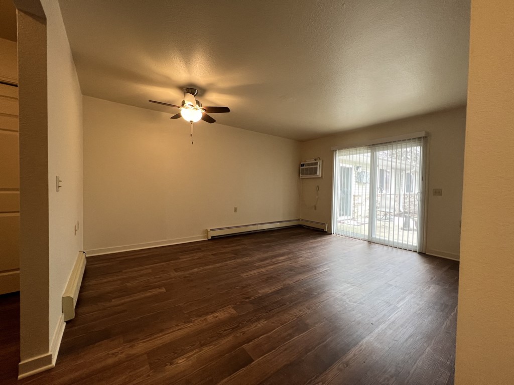 a bedroom with hardwood floors and a ceiling fan
