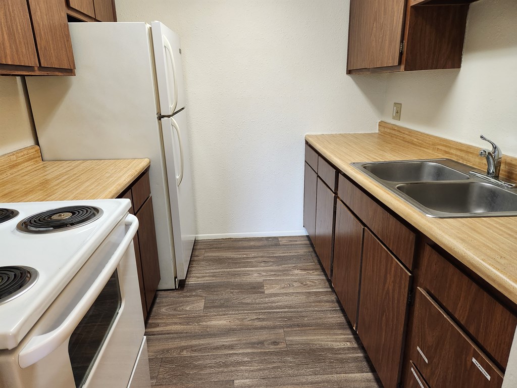 a kitchen with a stove sink and refrigerator