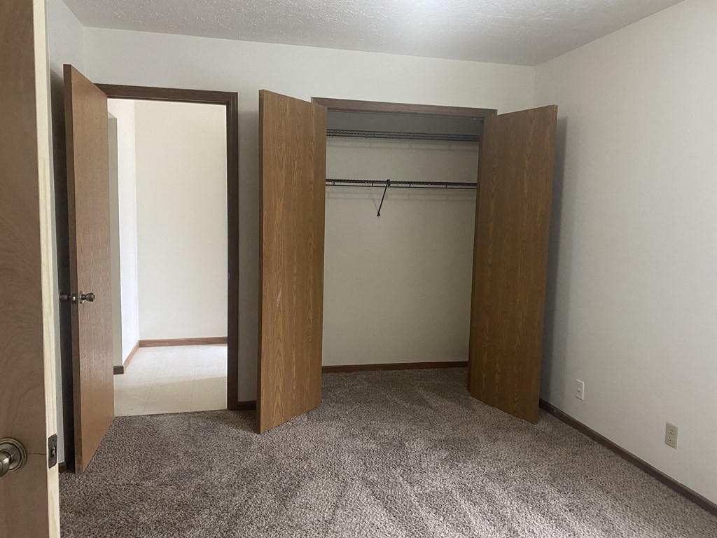 a bedroom with a closet and an open door