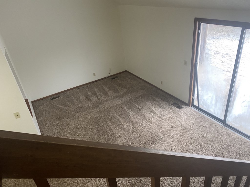 an empty room with a sliding glass door