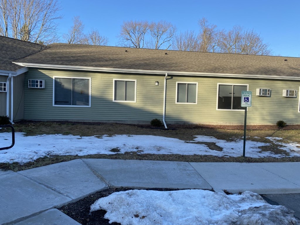 a yellow house with a yard covered in snow