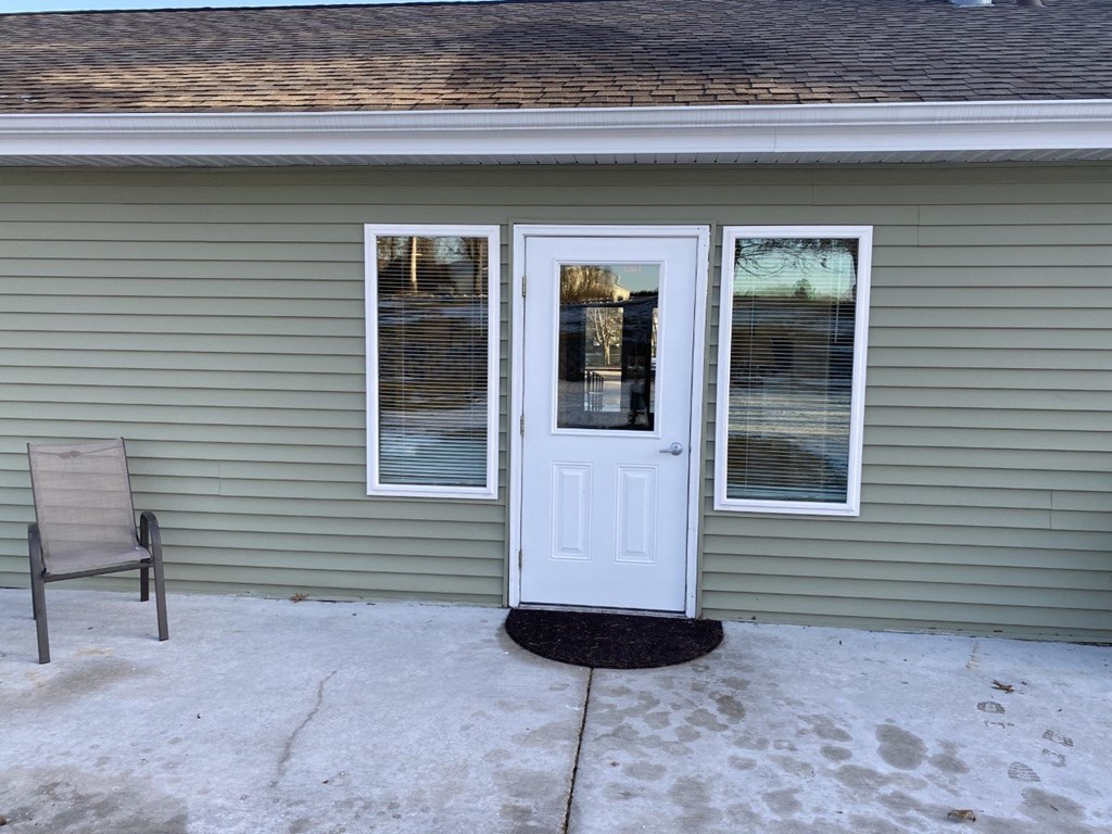 a front porch of a house with a white door