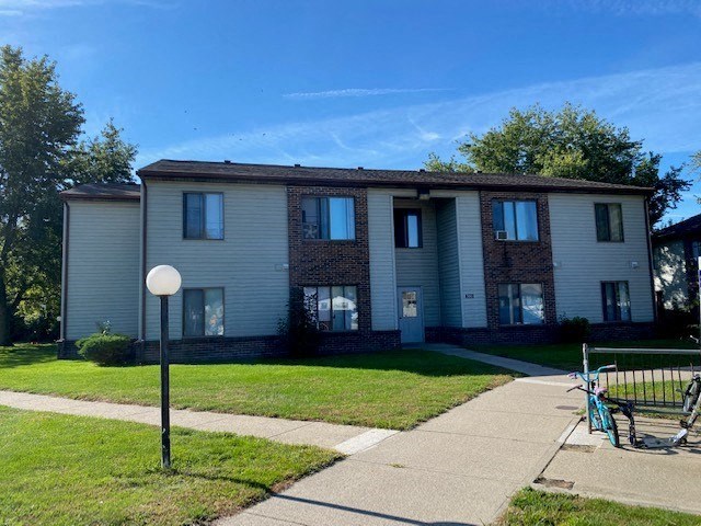a white house with a bike parked in front of it