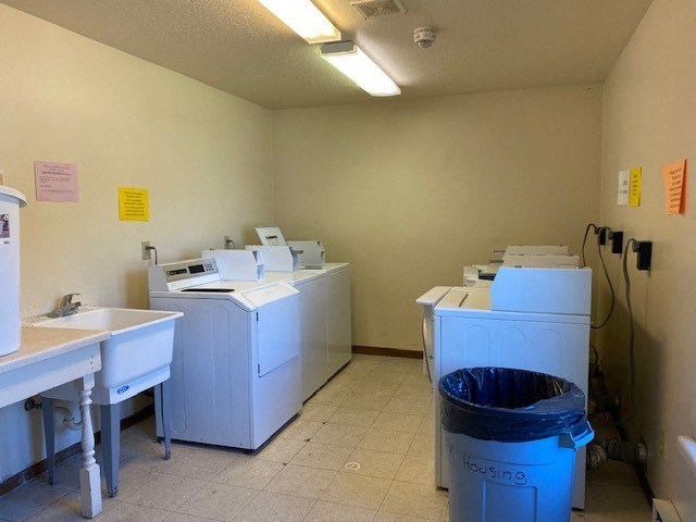 a laundry room with washing machines and sinks