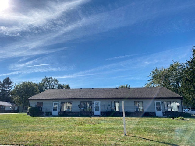 a white house with a yard and a blue sky