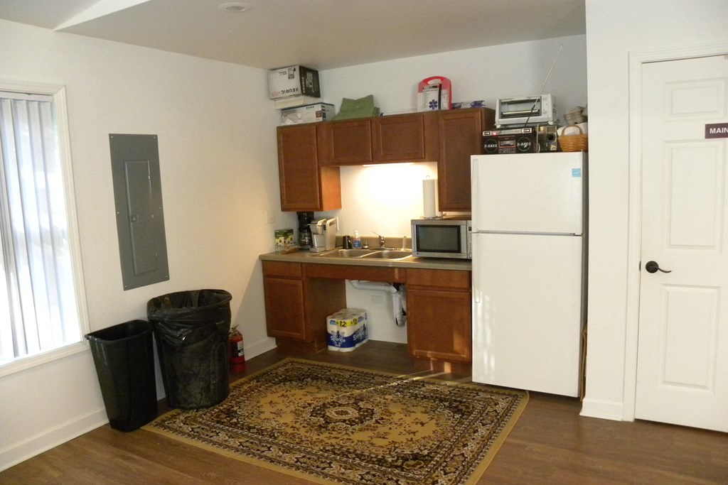 a small kitchen with a refrigerator and a sink