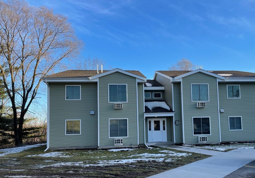 the front of a house with snow on the ground