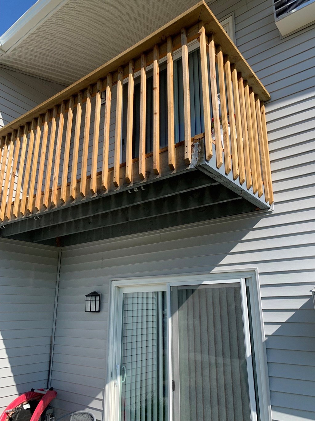 a balcony with a wooden railing on a house