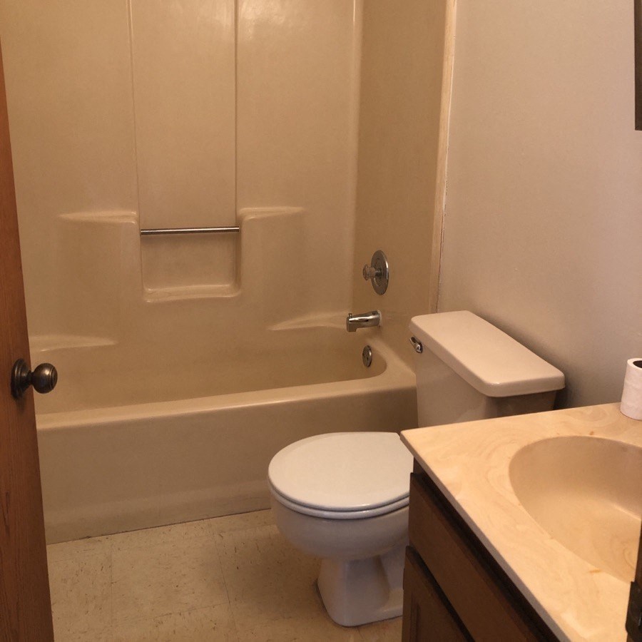 a bathroom with a toilet sink and bathtub