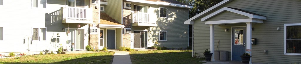 a row of houses with a sidewalk in front of them