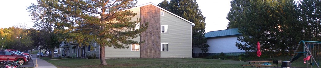 a small house with a tree in front of it
