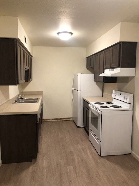 a kitchen with a stove and a refrigerator