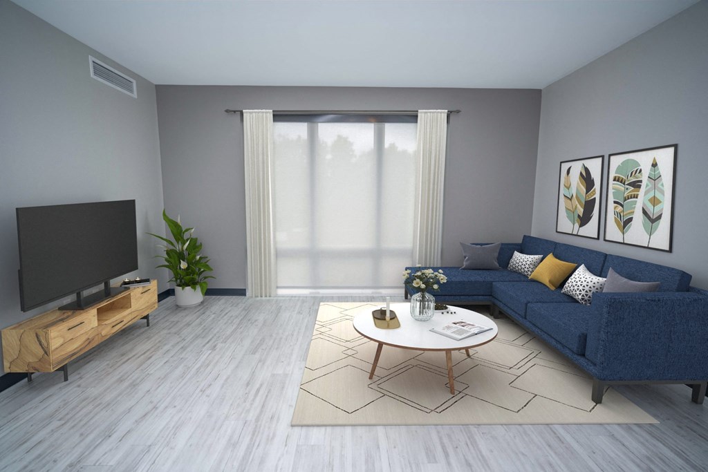 a living room with a blue couch and a coffee table in front of a tv