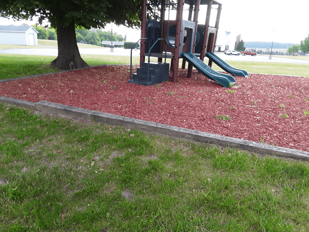 a playground with two slides and a swing set