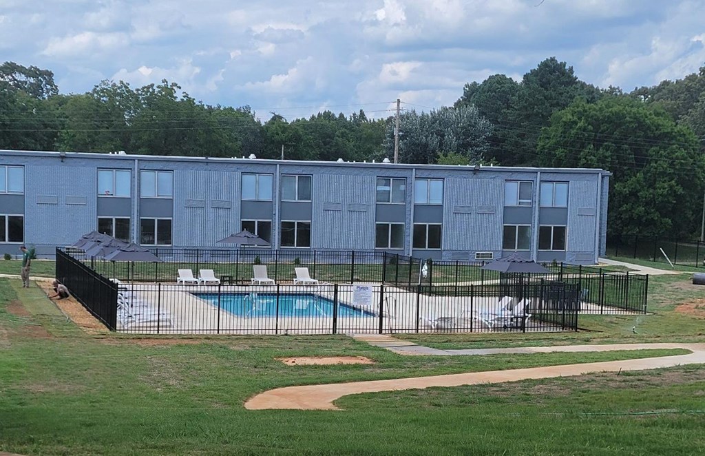 a building with a swimming pool in front of it