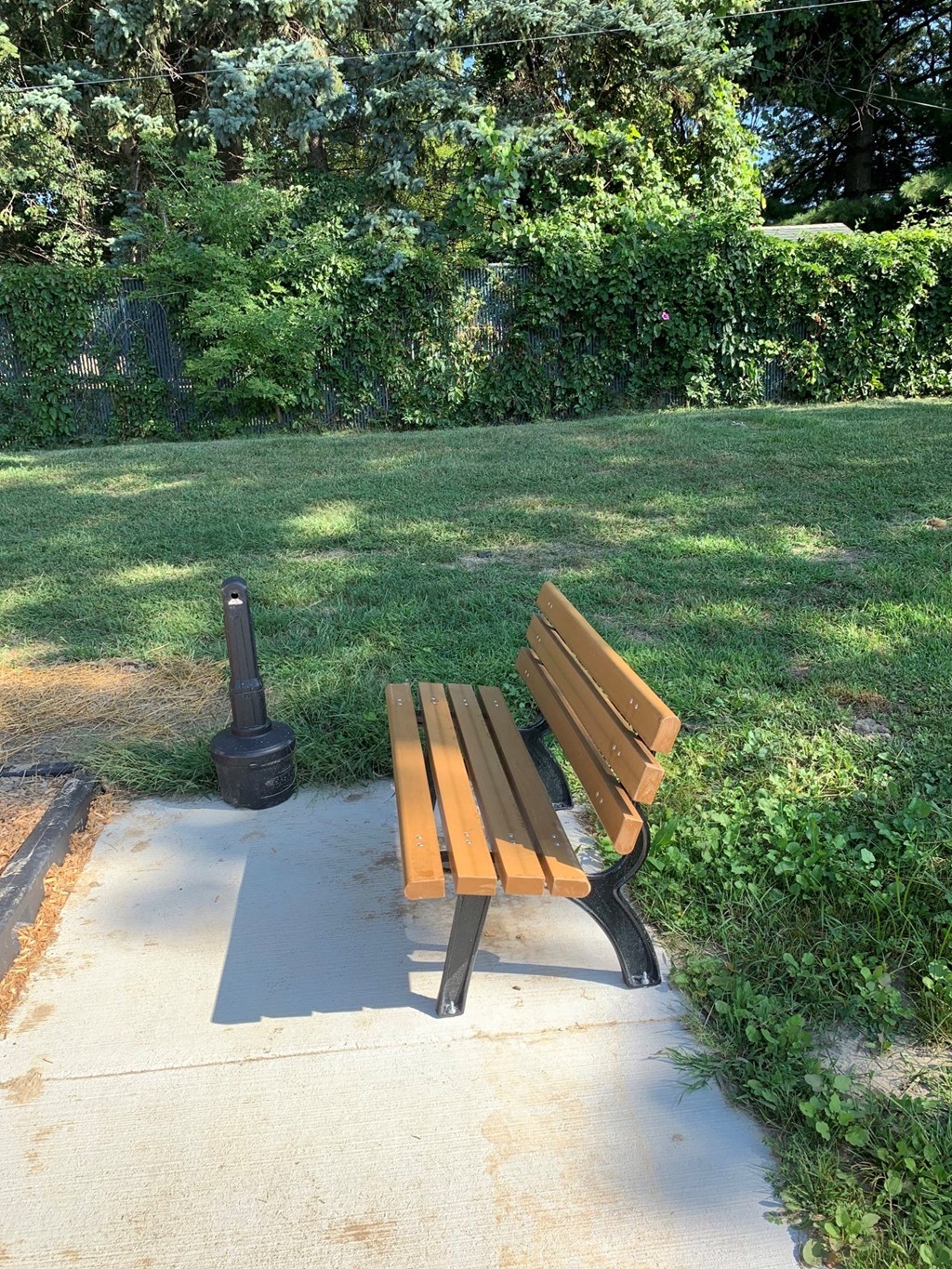 a wooden park bench sitting in the grass
