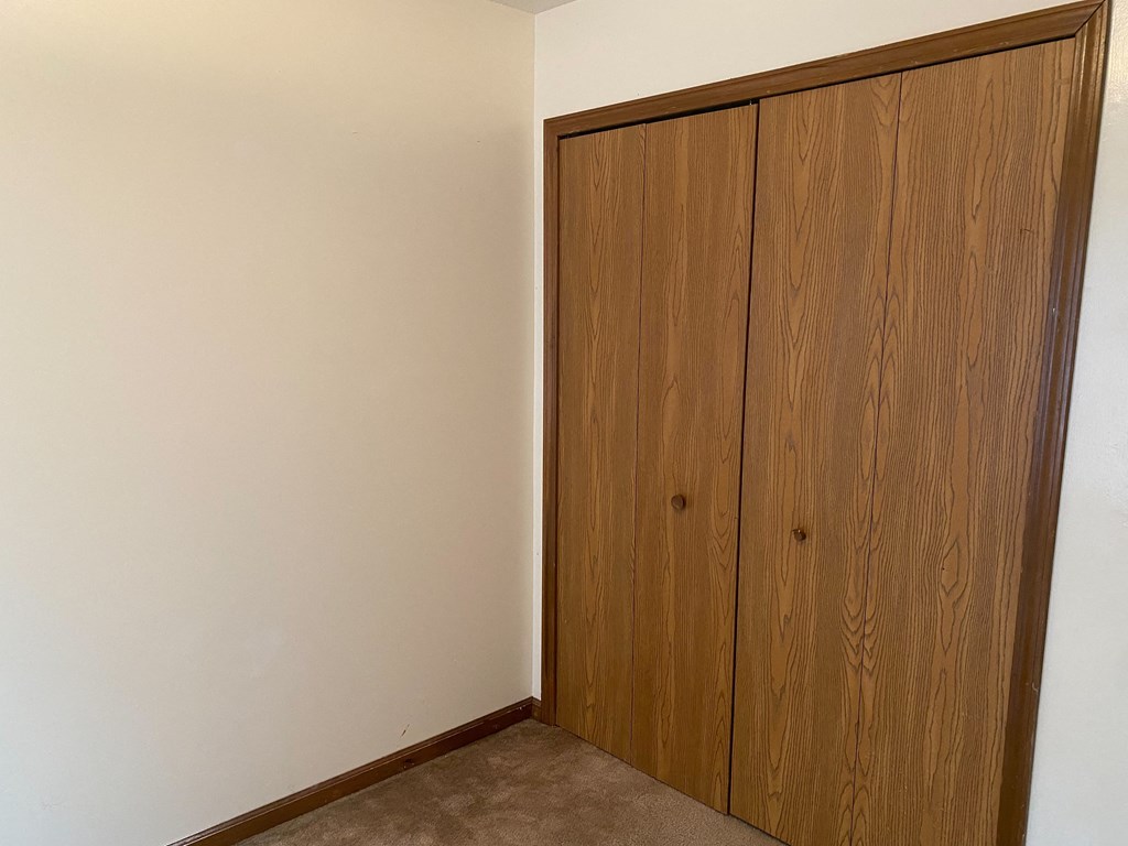 an empty room with a wooden door