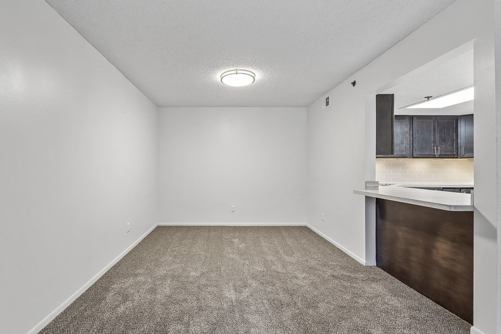 a bedroom with a medium sized bed and a kitchenette